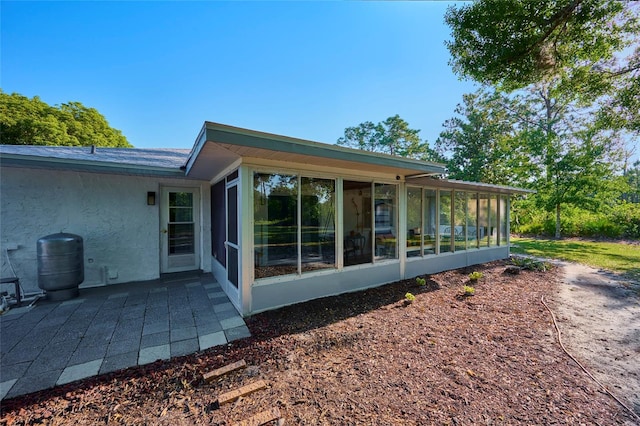 back of house with a sunroom