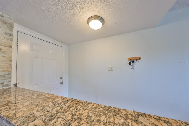 empty room featuring a textured ceiling