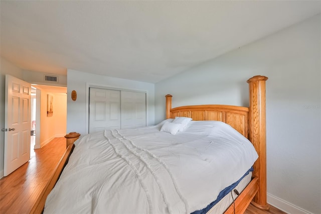 bedroom with hardwood / wood-style floors and a closet