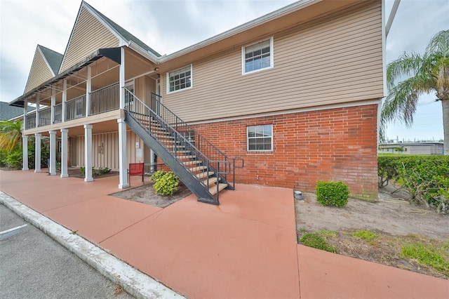 back of house featuring a sunroom and a patio area