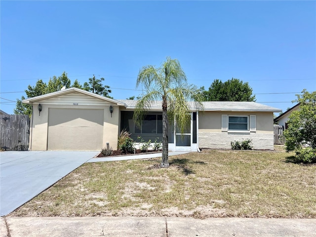 single story home with a front yard and a garage