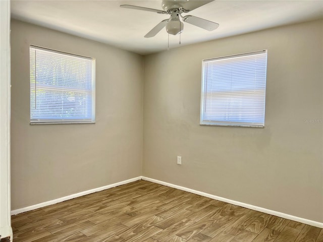 spare room featuring light hardwood / wood-style flooring and ceiling fan