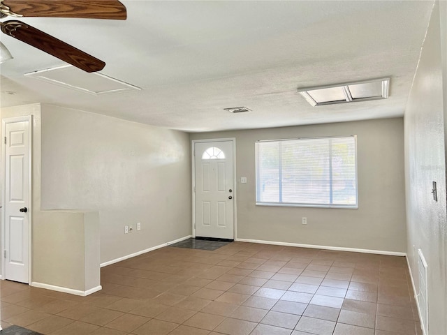 tiled entryway featuring ceiling fan