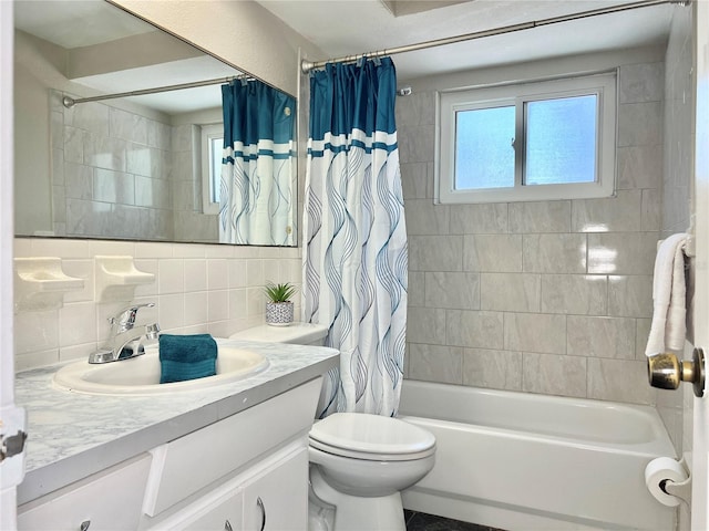 full bathroom featuring toilet, shower / bath combo with shower curtain, backsplash, vanity, and tile walls