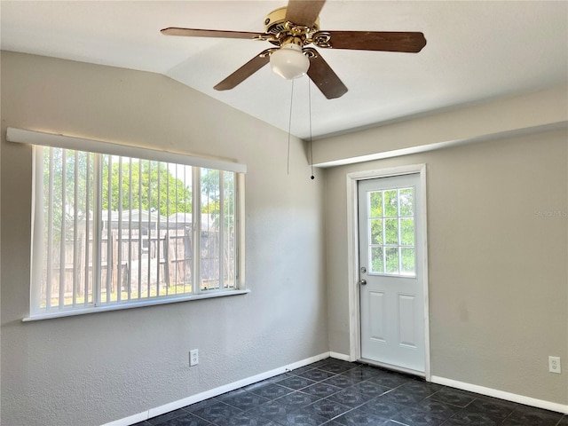 tiled foyer entrance featuring ceiling fan and lofted ceiling