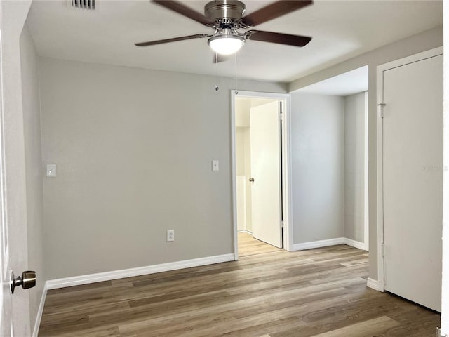 spare room featuring light hardwood / wood-style floors and ceiling fan