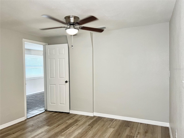 unfurnished room featuring hardwood / wood-style flooring and ceiling fan