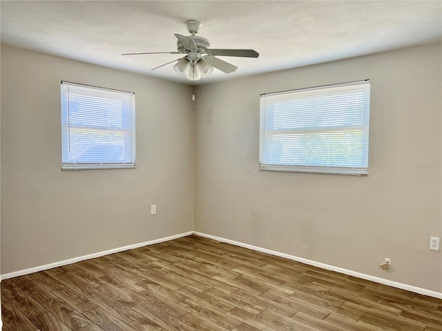 unfurnished room with ceiling fan and hardwood / wood-style floors