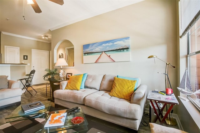 living room featuring wood-type flooring, ceiling fan, and ornamental molding