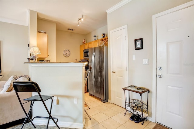 kitchen featuring light brown cabinets, light tile floors, crown molding, stainless steel appliances, and kitchen peninsula