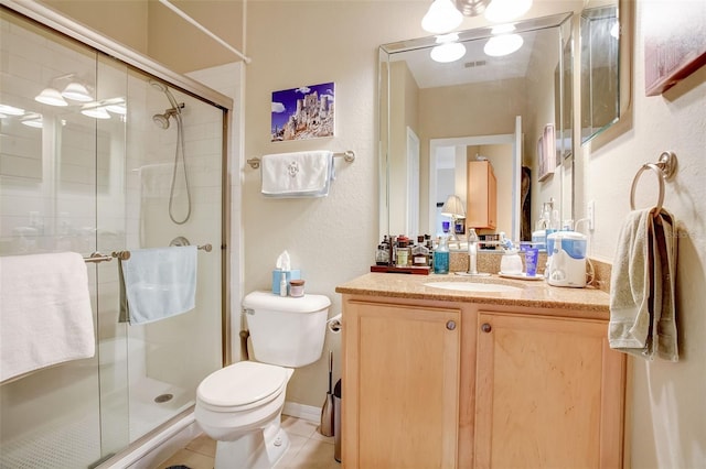 bathroom with walk in shower, vanity, toilet, and tile flooring