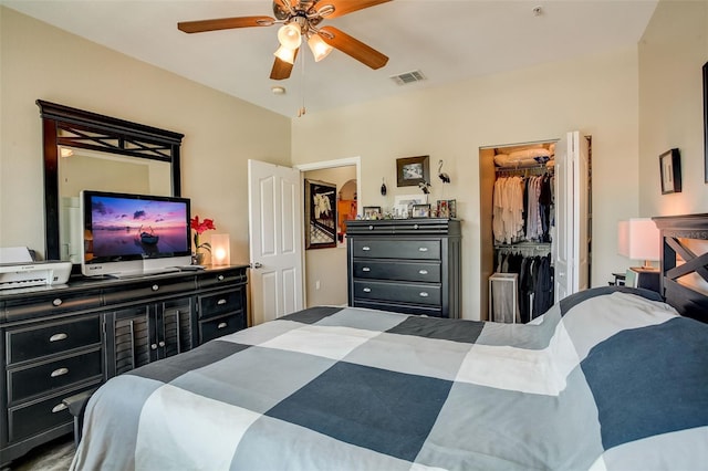 bedroom with a spacious closet, ceiling fan, and a closet