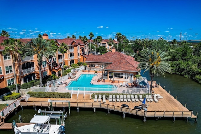 view of dock featuring a community pool, a patio area, and a water view