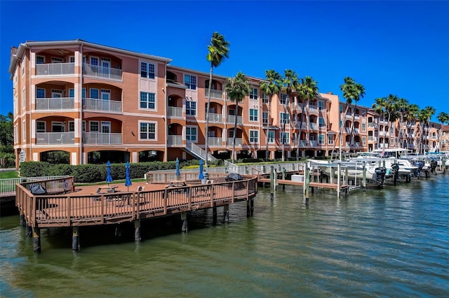 view of dock with a water view and a balcony