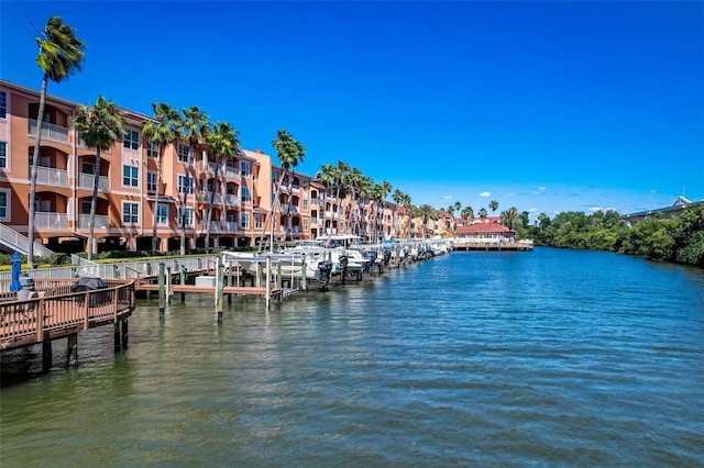 dock area with a water view and a balcony