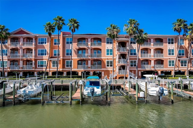 dock area with a water view and a balcony