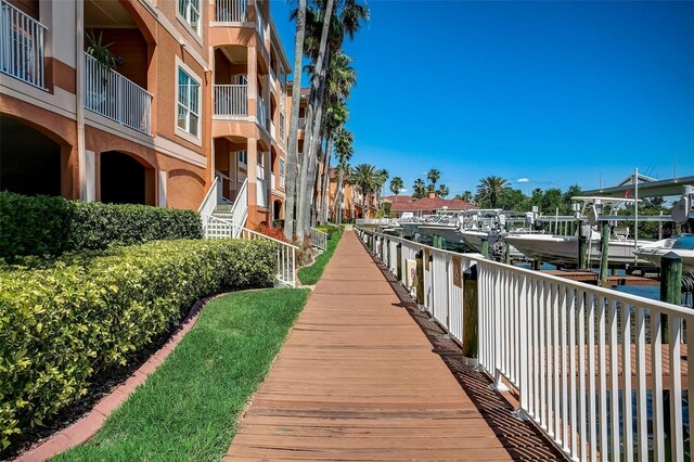 view of home's community featuring boat lift and a dock