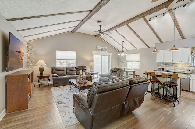 living room with high vaulted ceiling, beam ceiling, light wood-type flooring, and ceiling fan with notable chandelier