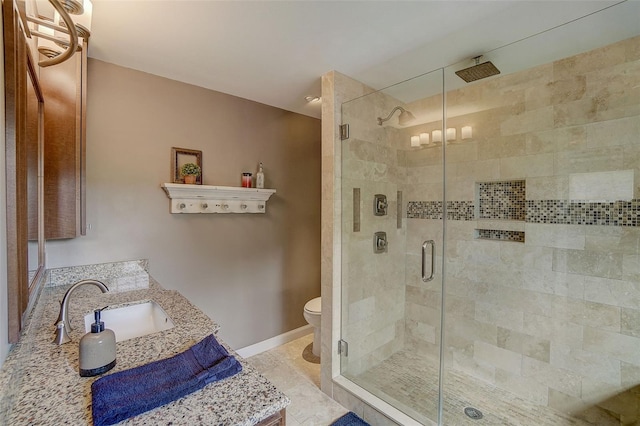 bathroom with walk in shower, tile flooring, vanity, and toilet