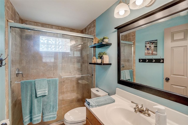 bathroom with vanity with extensive cabinet space, walk in shower, and toilet