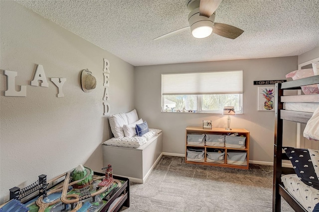 carpeted bedroom featuring a textured ceiling and ceiling fan