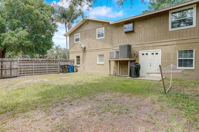 back of property featuring a lawn