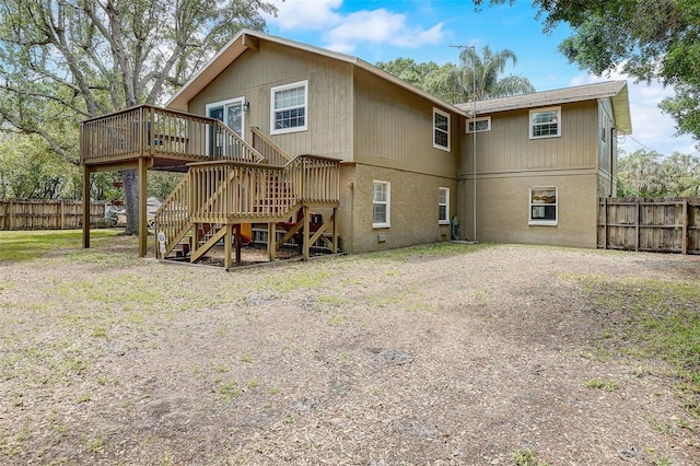 rear view of house featuring a deck