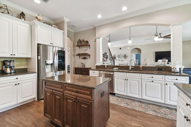 kitchen with appliances with stainless steel finishes, ceiling fan, white cabinets, sink, and dark hardwood / wood-style floors