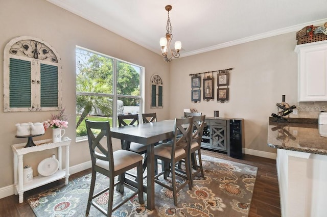 dining area featuring ornamental molding, a notable chandelier, and dark hardwood / wood-style flooring