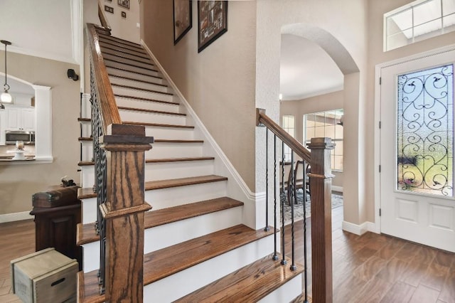 foyer with dark hardwood / wood-style flooring and ornamental molding