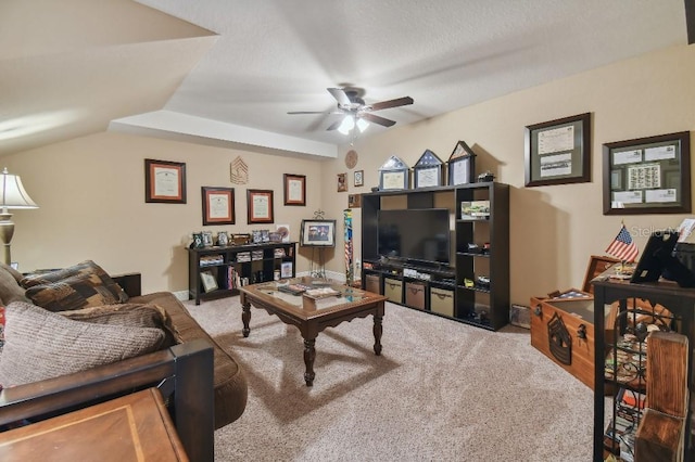 living room with carpet flooring, ceiling fan, and vaulted ceiling