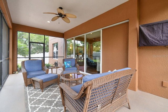 sunroom / solarium featuring ceiling fan