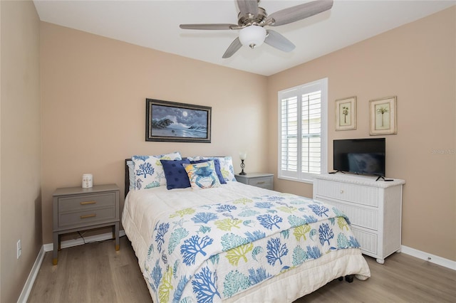 bedroom with ceiling fan and hardwood / wood-style flooring