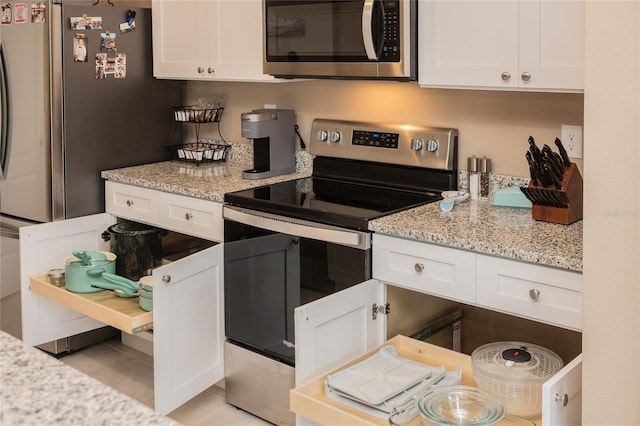 kitchen with appliances with stainless steel finishes and white cabinets