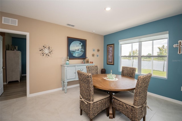 dining space featuring light tile flooring