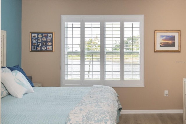 bedroom featuring hardwood / wood-style floors and multiple windows