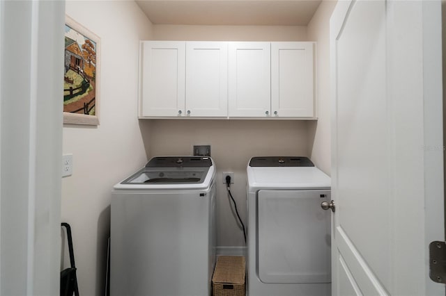 washroom with cabinets, hookup for a washing machine, and washer and clothes dryer