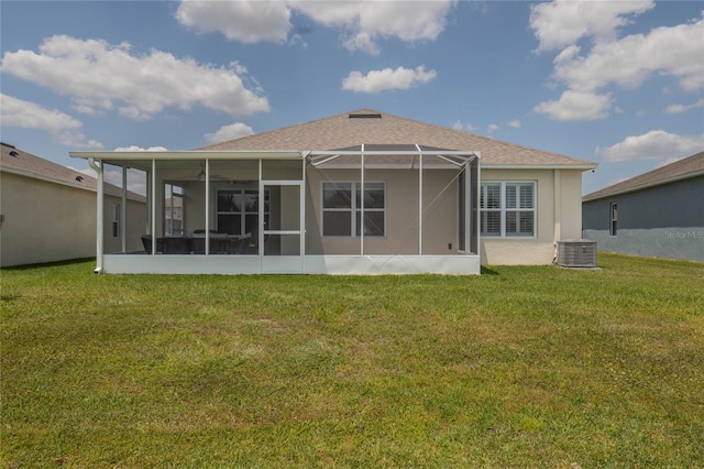 rear view of property with a yard, central AC, and glass enclosure