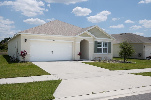 view of front of property with a garage and a front yard