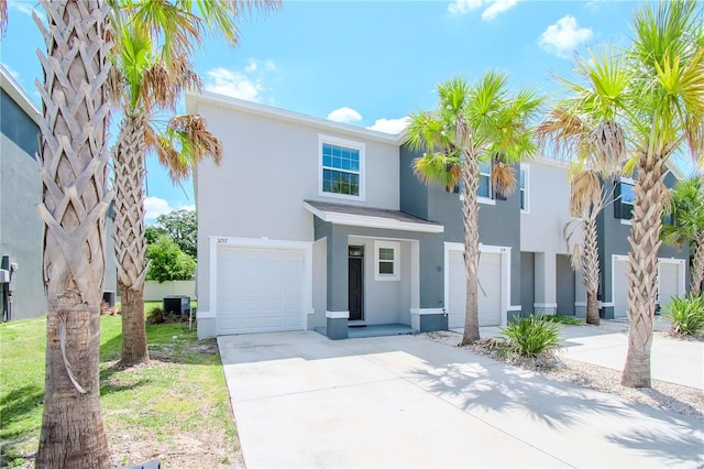 view of front of home with a garage and central AC unit