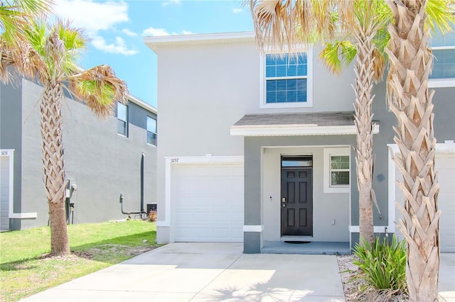 view of front of home with a front yard and a garage