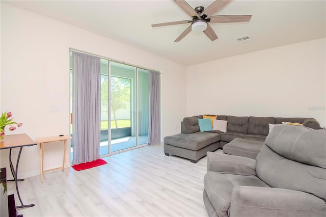 living room featuring light hardwood / wood-style floors and ceiling fan