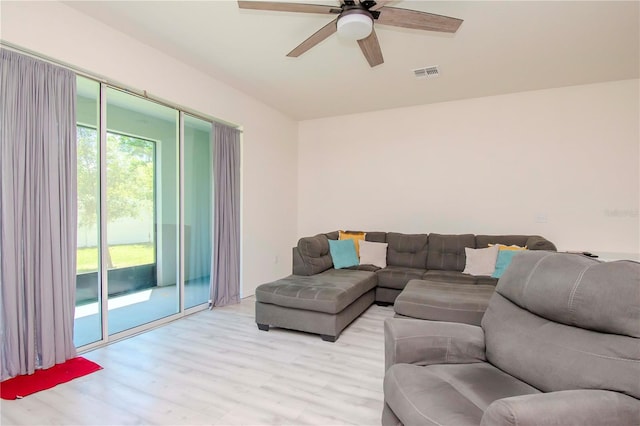 living room with light hardwood / wood-style floors and ceiling fan