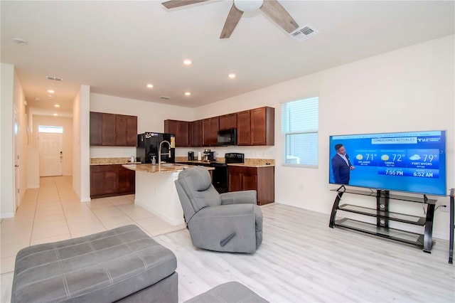 tiled living room featuring ceiling fan