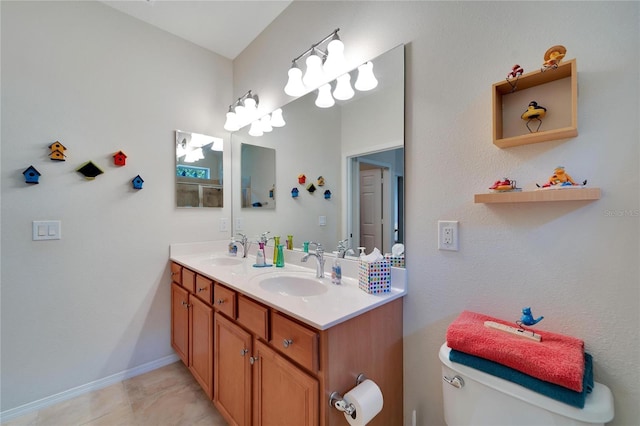 bathroom with tile patterned floors, vanity, and toilet