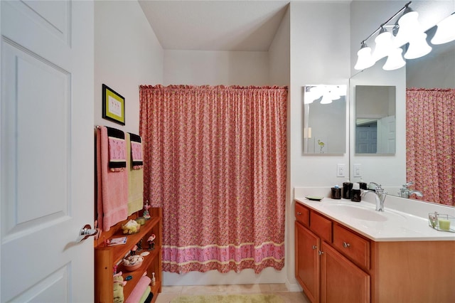 bathroom with tile patterned flooring, shower / tub combo, and vanity