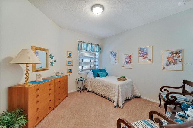 carpeted bedroom featuring a textured ceiling