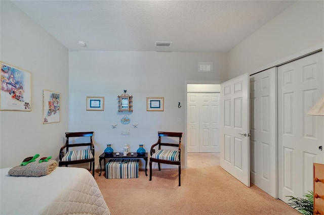 carpeted bedroom featuring a textured ceiling