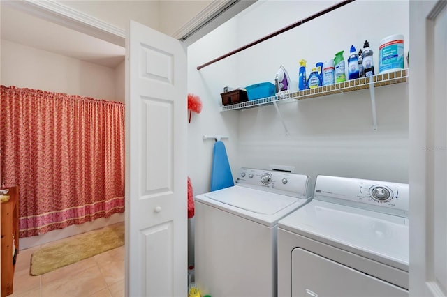 laundry room featuring light tile patterned floors and washing machine and clothes dryer