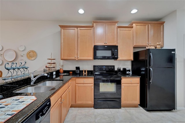 kitchen featuring dark stone counters, sink, black appliances, light brown cabinets, and light tile patterned floors